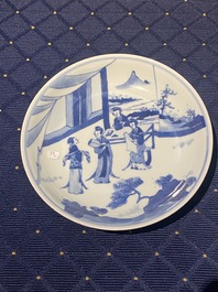 Een Chinese famille verte biscuit figuur, een groene 'lotus' pot en een blauw-wit bord met figuratief decor, Kangxi en later